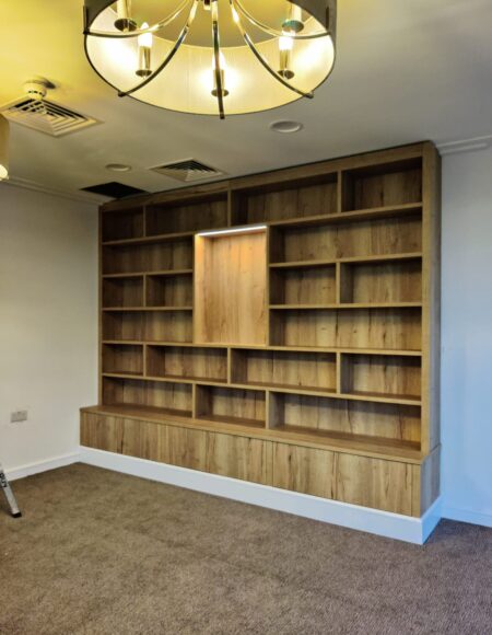 Manufacture and installation of bespoke fully fitted library cabinet at Kings Court Nursing Home, Holt.