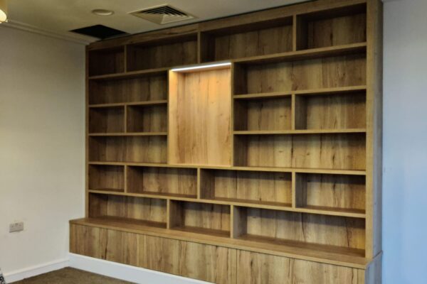 Manufacture and installation of bespoke fully fitted library cabinet at Kings Court Nursing Home, Holt.
