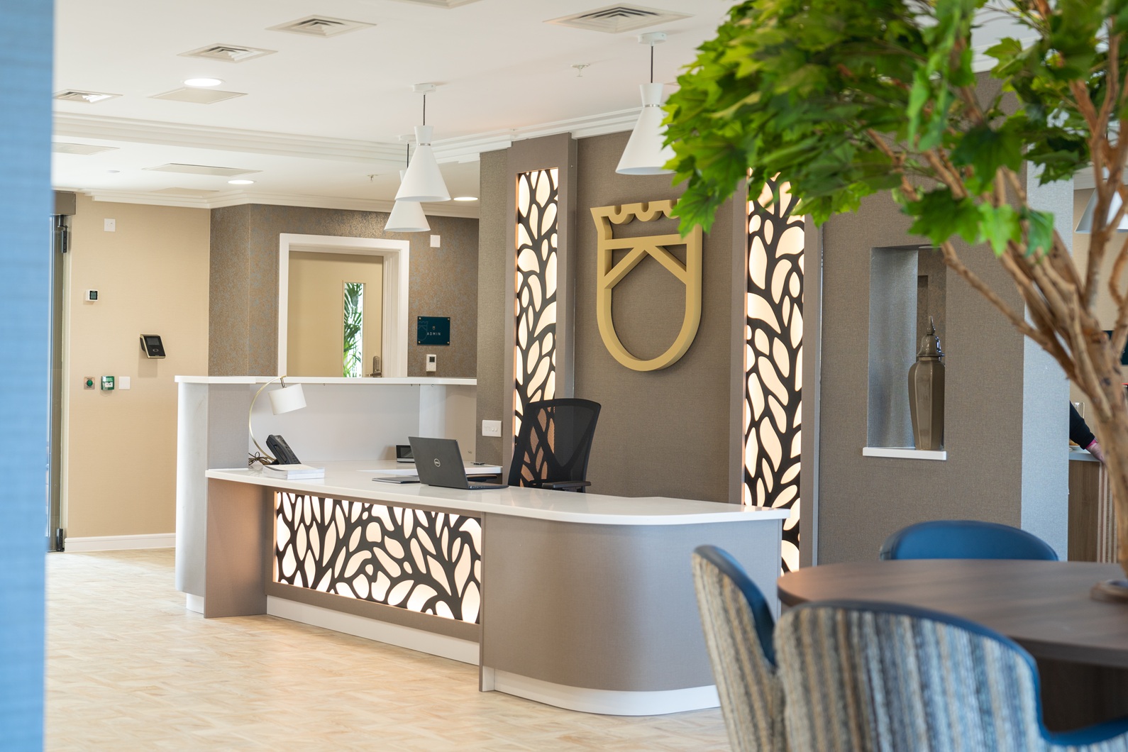 Curved bespoke reception desk with illuminated decorative panels